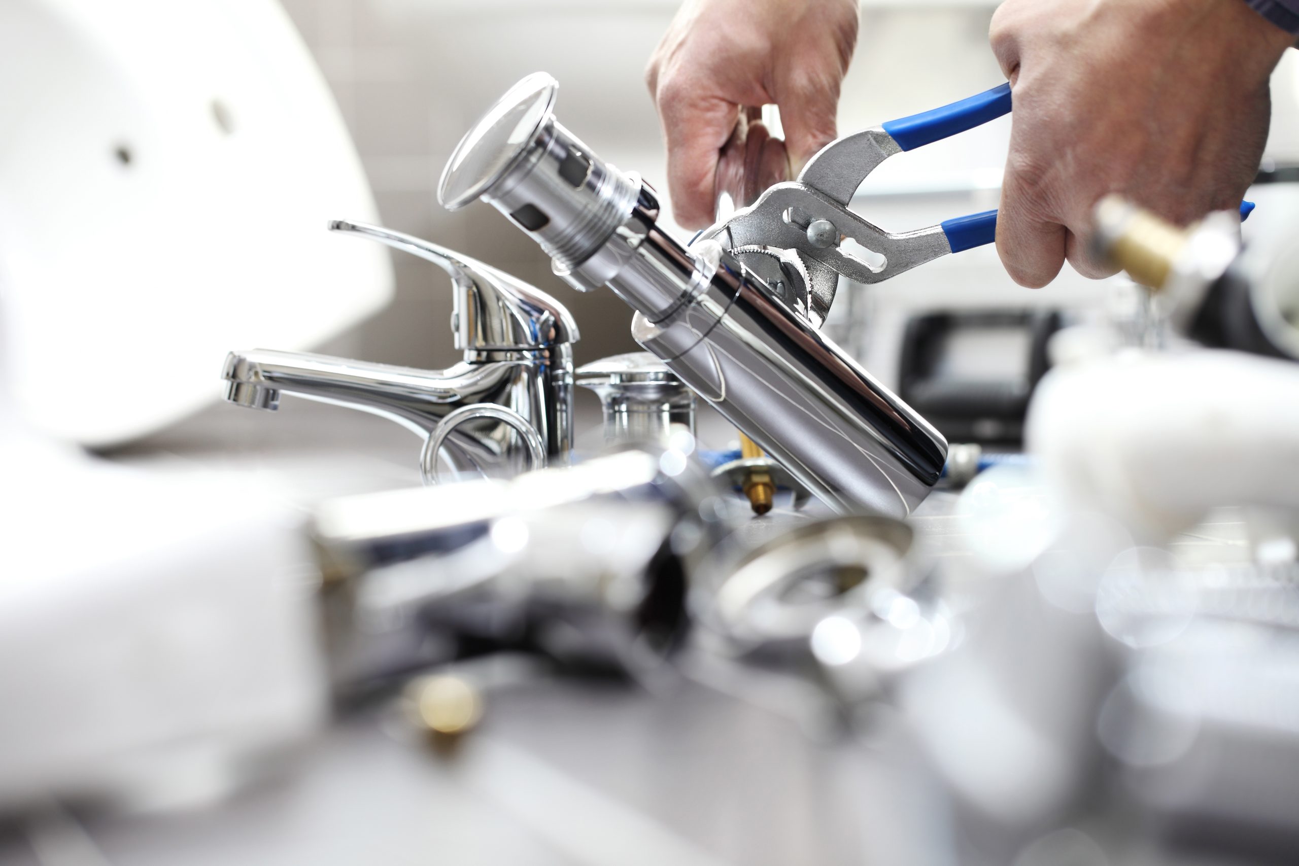 hands plumber at work in a bathroom, plumbing repair service, assemble and install concept